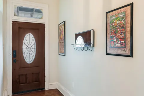 a view of a hallway with wooden door