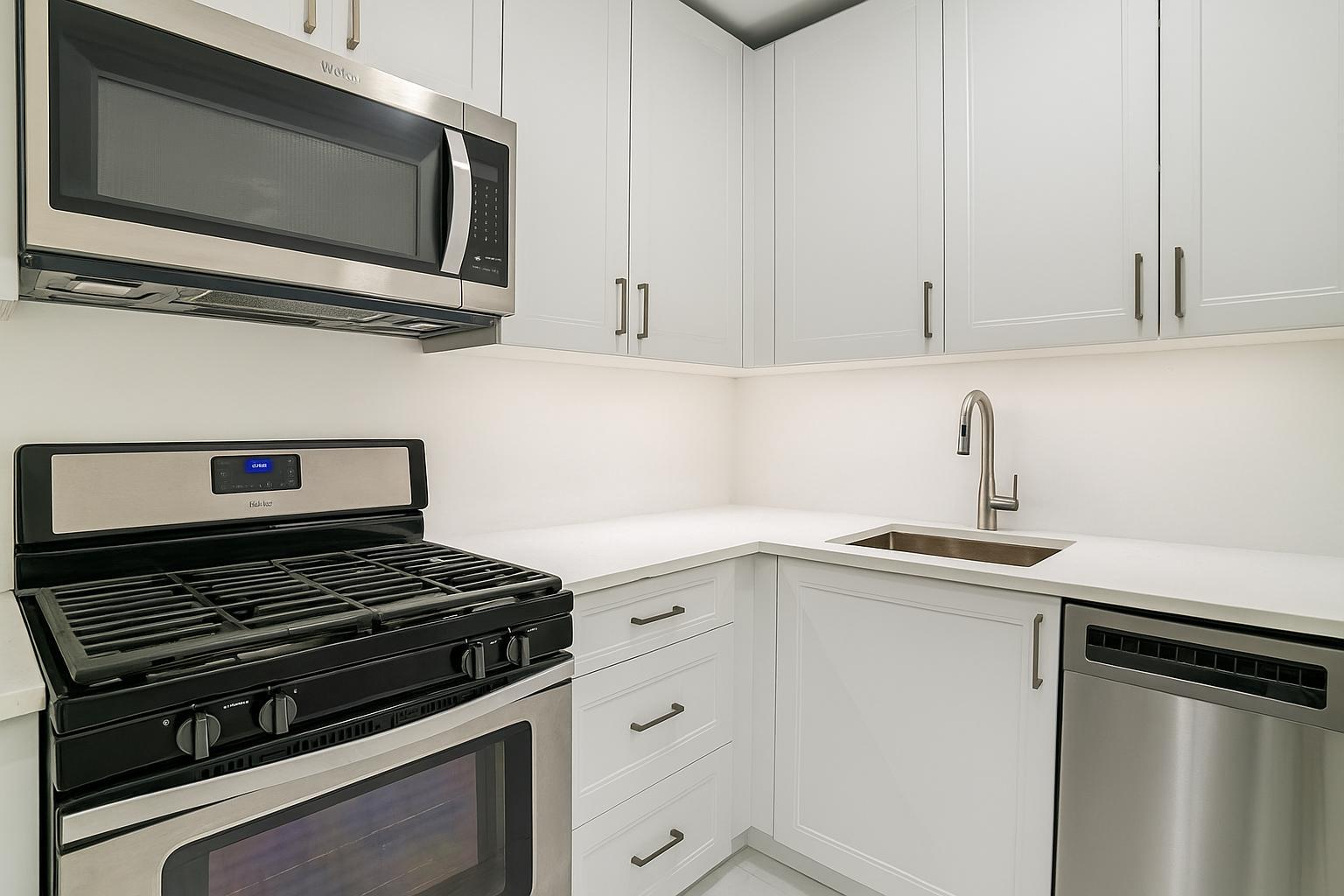 301 East 69th Street, Unit 3M Manhattan, NY 10021 - Photo 5 of 12 a kitchen with white cabinets and appliances