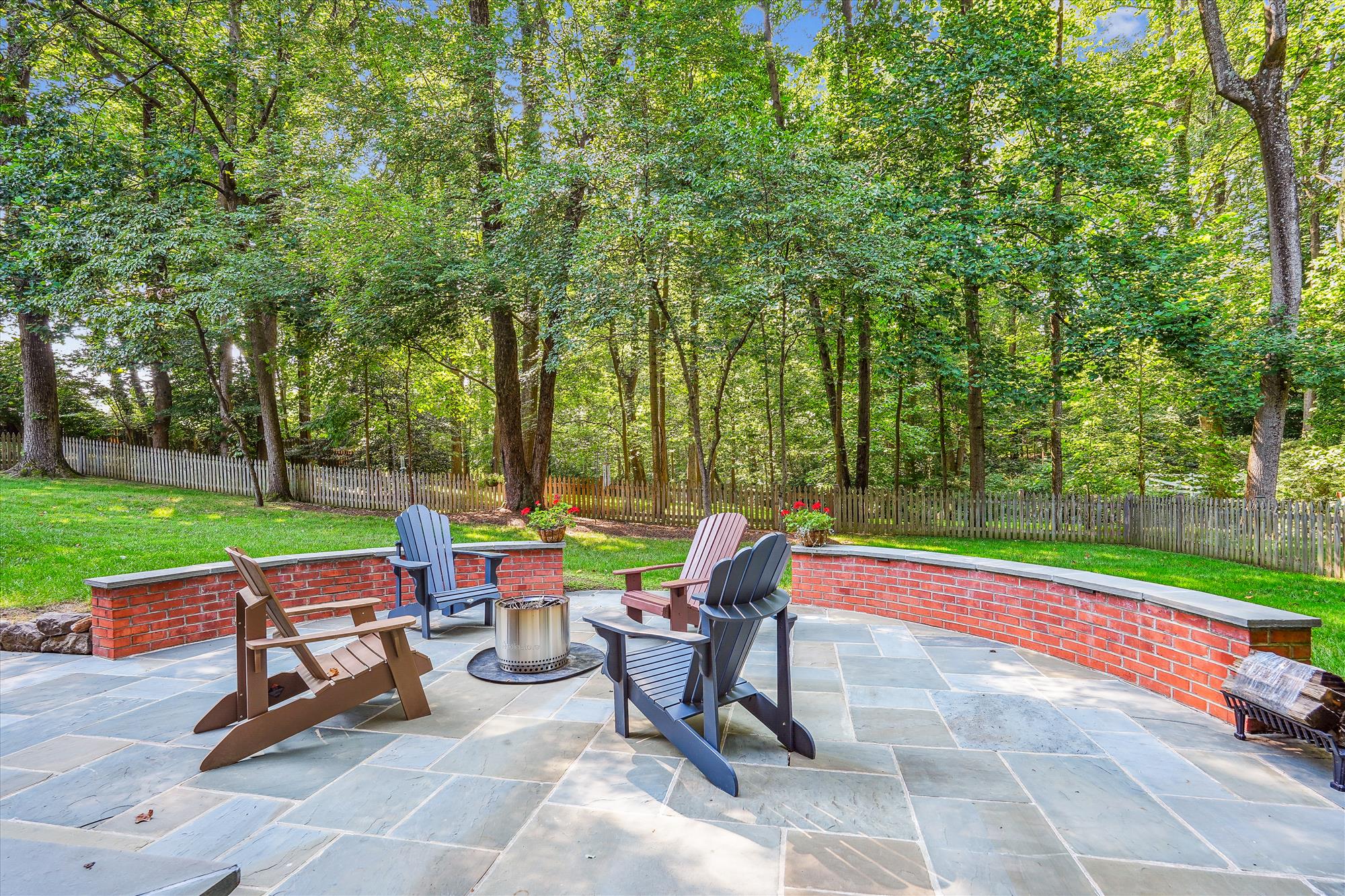 9904 Carter Road Bethesda, MD 20817 - Photo 41 of 41 a blue bench sitting in the middle of a park with large trees
