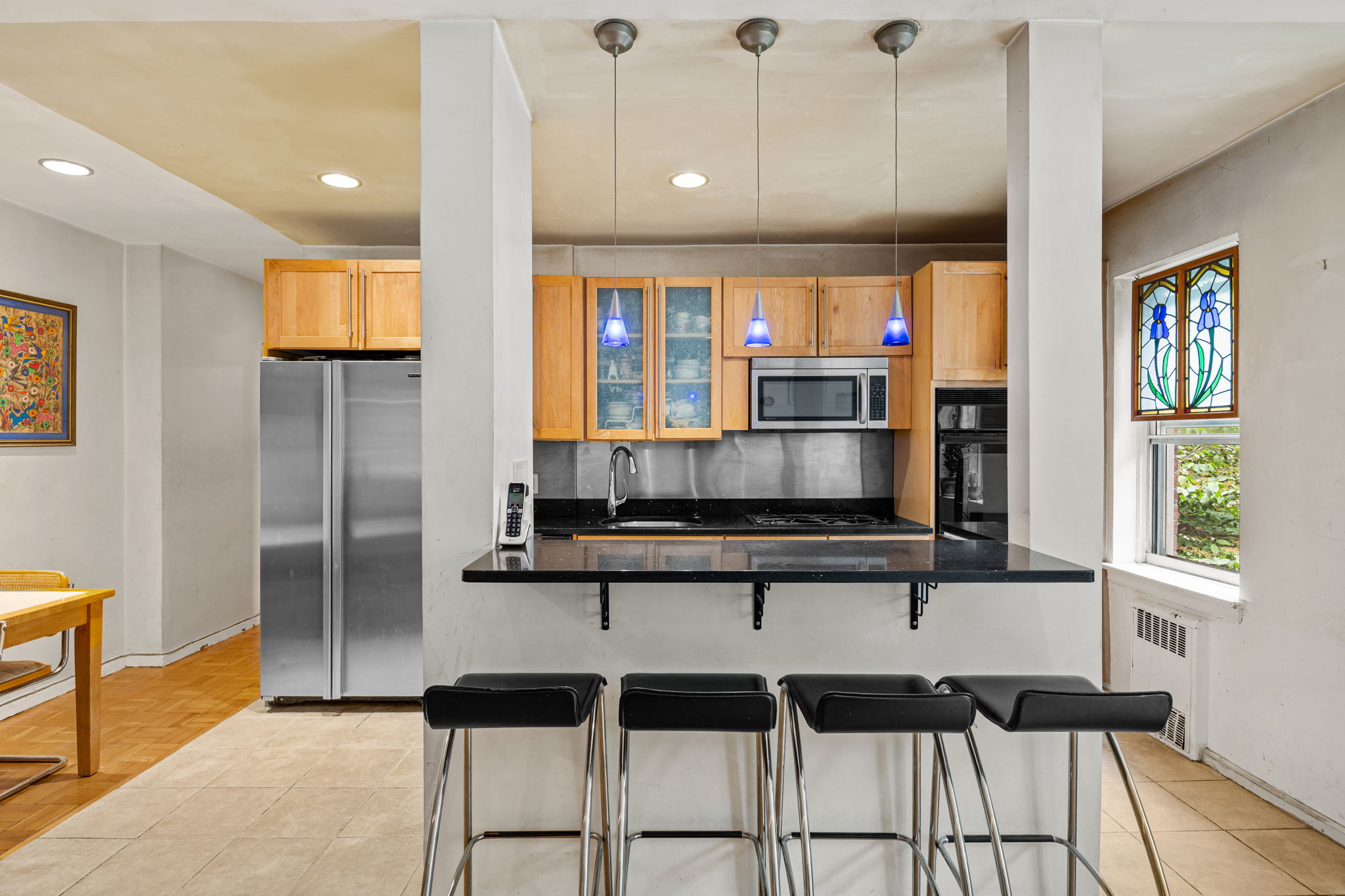 3850 Hudson Manor Terrace, Unit 1EE/2EE Bronx, NY 10463 - Photo 5 of 27 a kitchen with stainless steel appliances granite countertop a stove and cabinets
