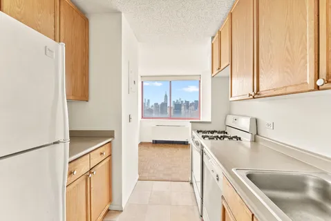 a kitchen with a stove a refrigerator and a sink
