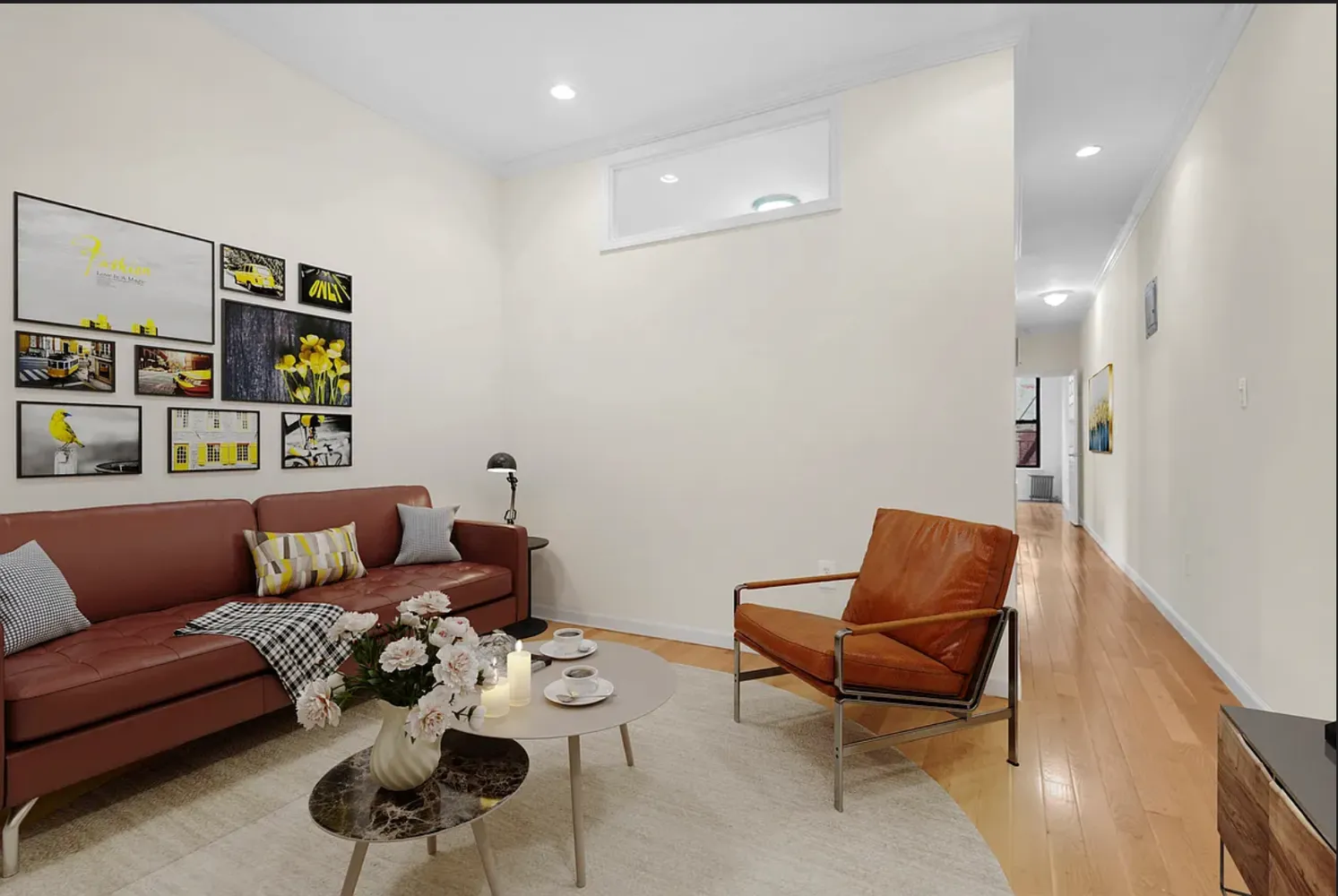 a living room with furniture and wooden floor