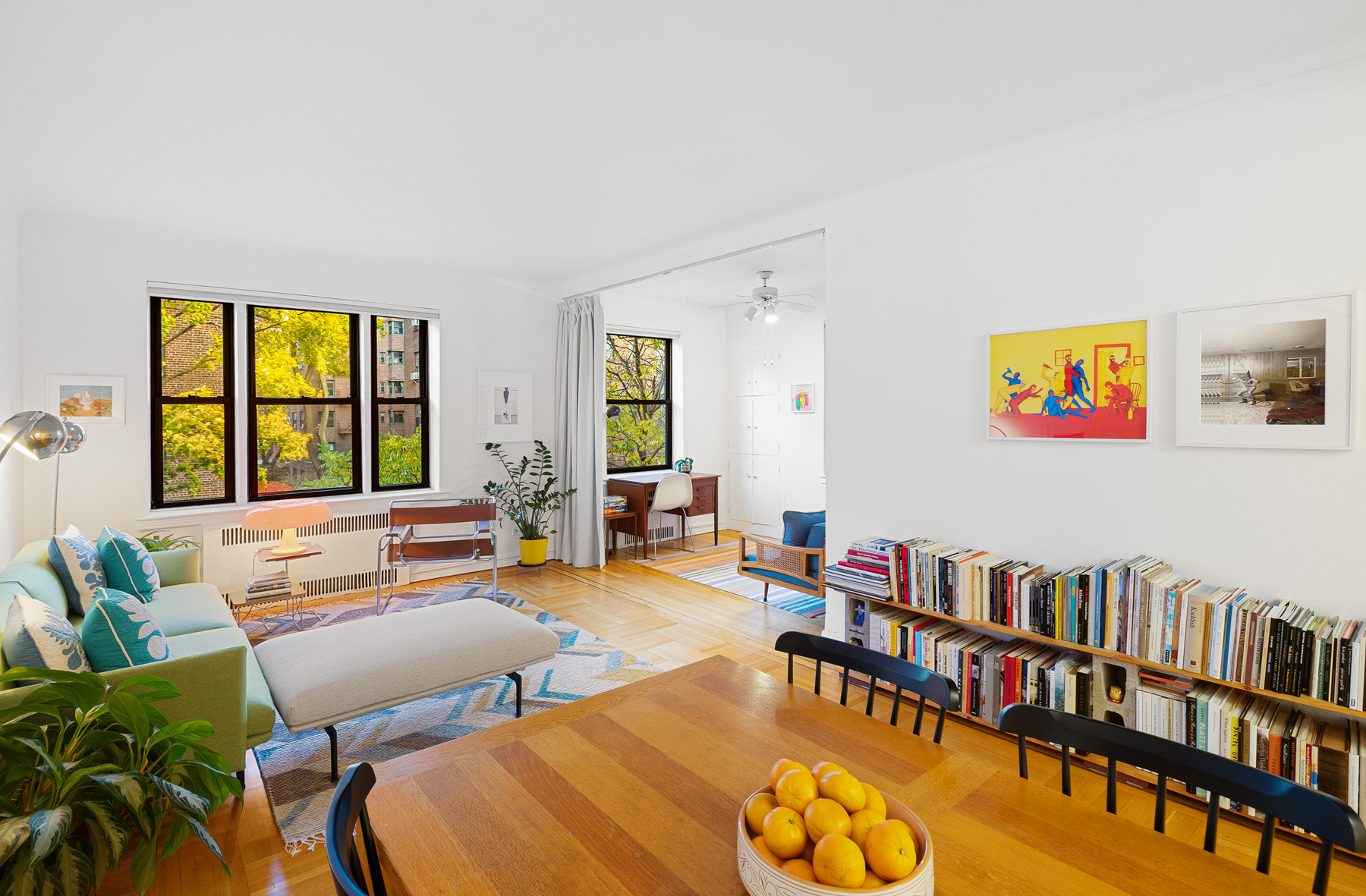 77-11 35th Avenue, Unit 3N Queens, NY 11372 - Photo 5 of 21 a living room with furniture and a window