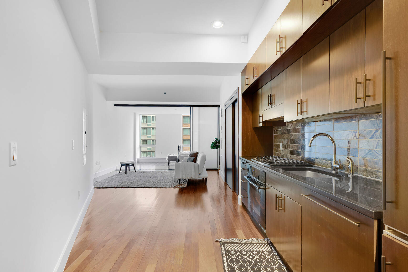 150 Myrtle Avenue, Unit 602 Brooklyn, NY 11201 - Photo 27 of 29 a large kitchen with stainless steel appliances granite countertop a lot of counter space and a sink