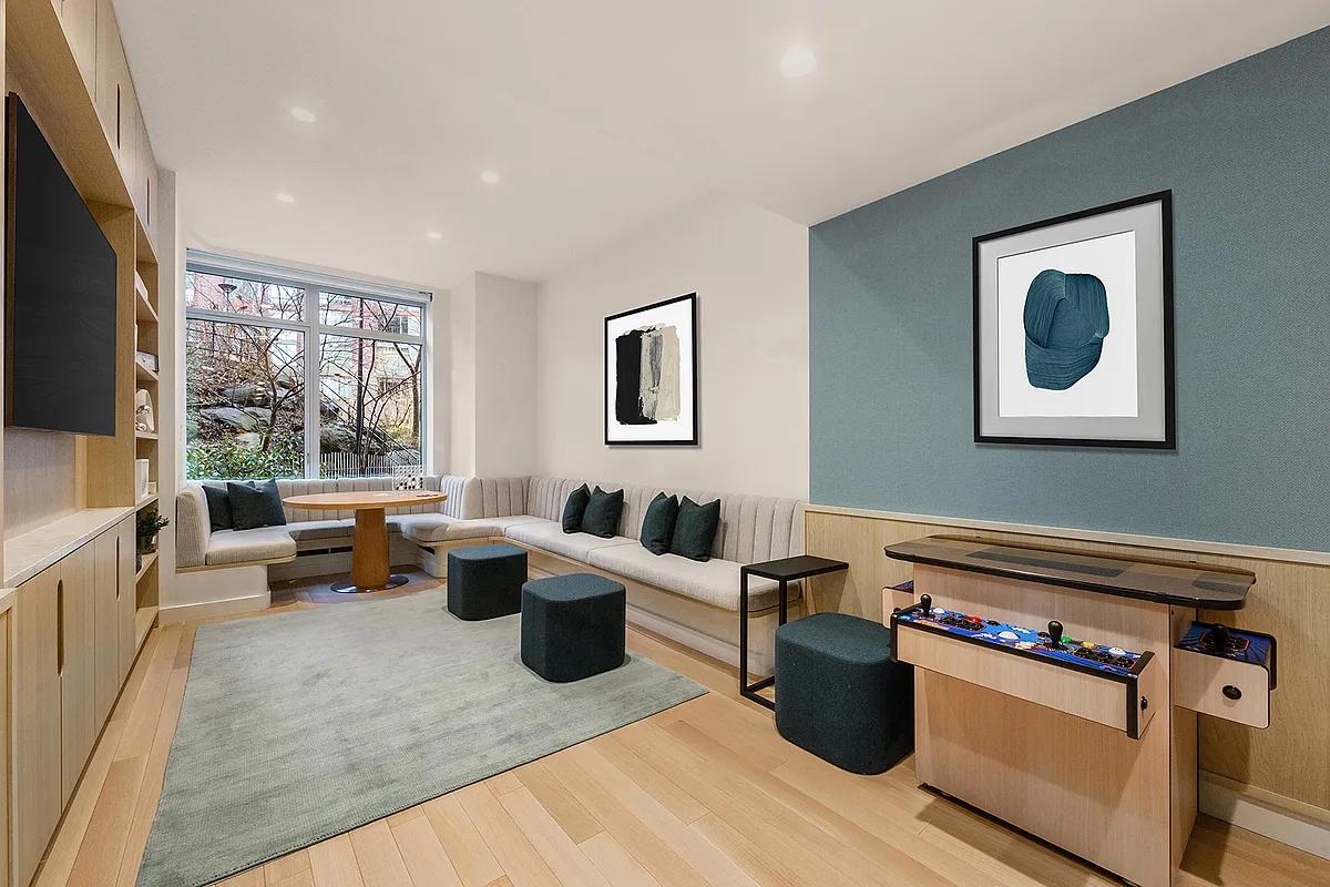 20 River Terrace, Unit 14C Manhattan, NY 10282 - Photo 9 of 18 a living room with furniture and a flat screen tv