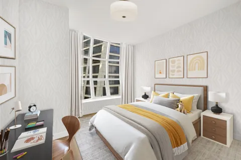 a bedroom with furniture and a window