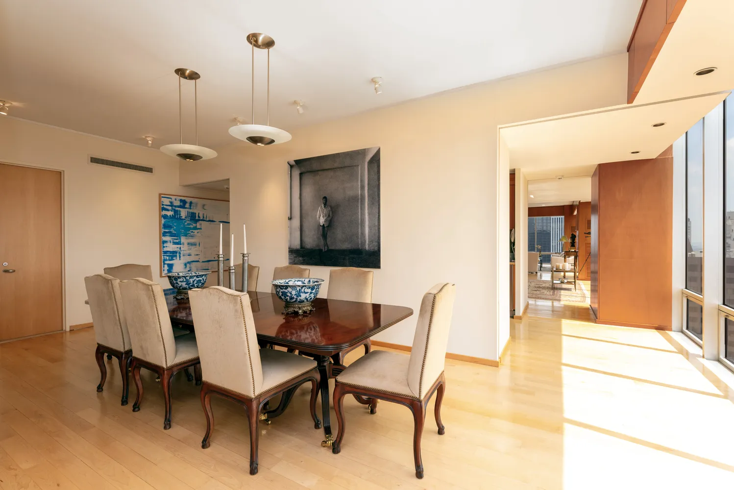 a bedroom with a large window and a balcony