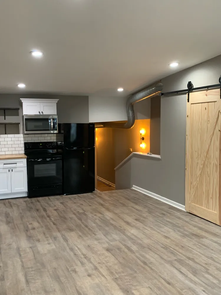 a kitchen with a refrigerator and a stove top oven