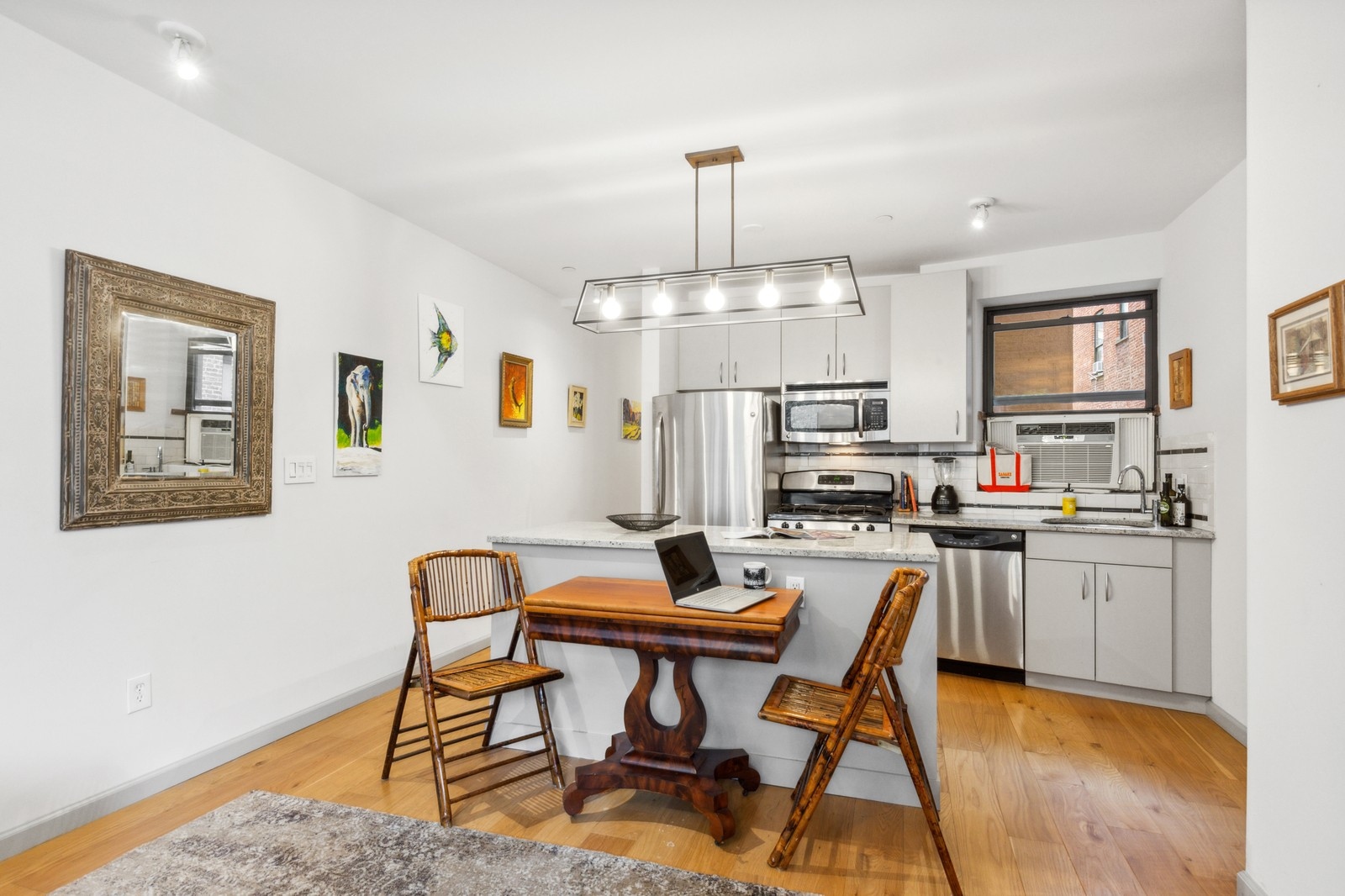 250 Manhattan Avenue, Unit 3A Manhattan, NY 10026 - Photo 3 of 15 a kitchen with stainless steel appliances a dining table chairs and a refrigerator