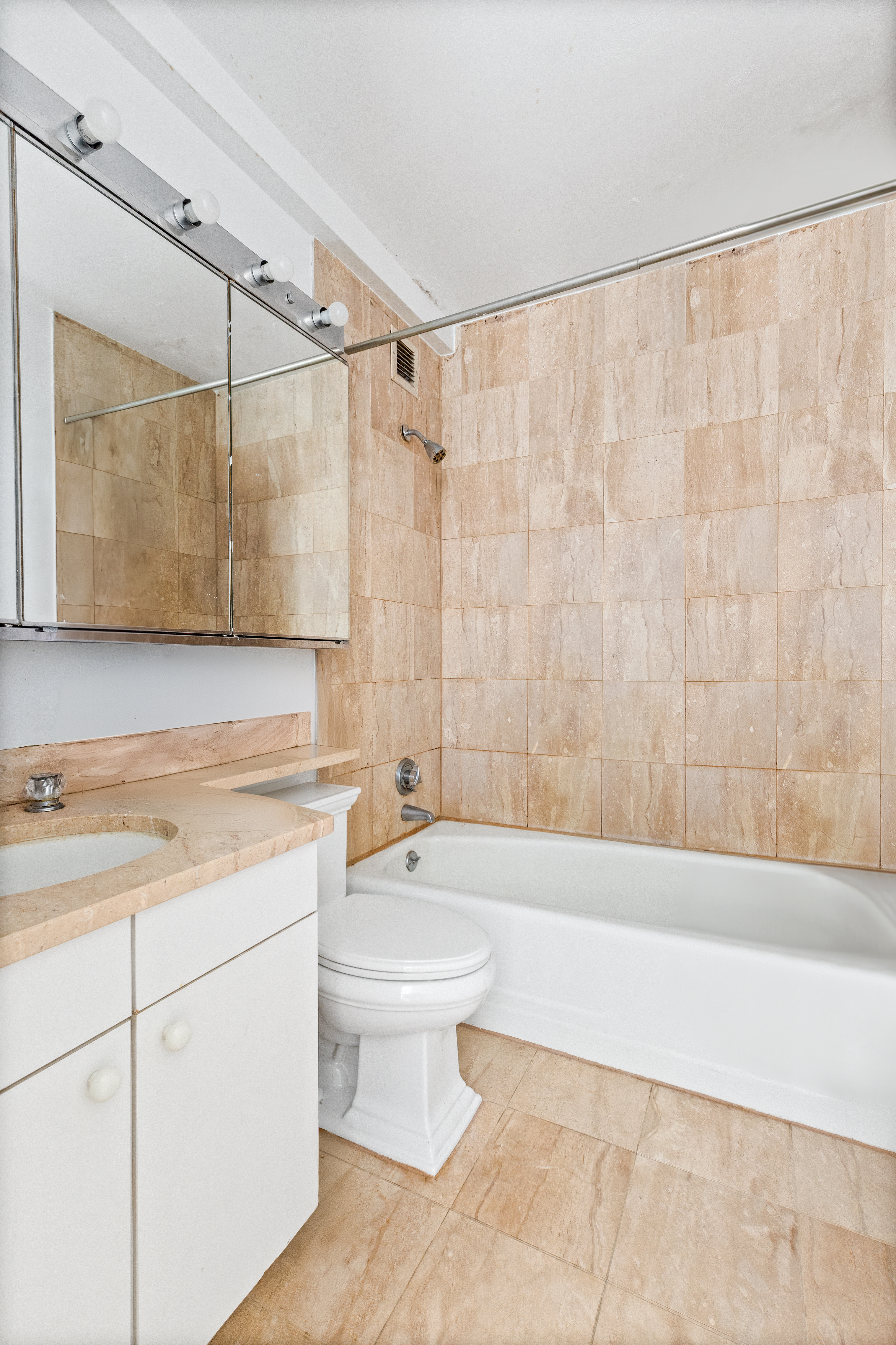 2000 Broadway, Unit 8I Manhattan, NY 10023 - Photo 5 of 9 a bathroom with a sink a toilet and bathtub