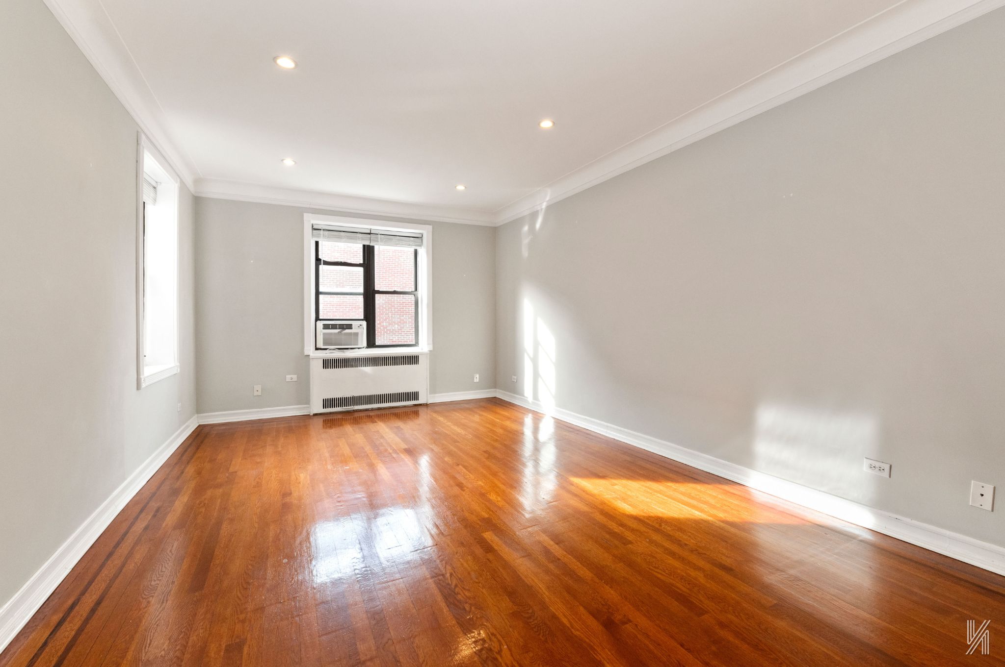 25-40 31st Avenue, Unit 6E Queens, NY 11106 - Photo 12 of 15 a view of empty room with wooden floor and fan