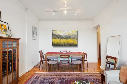 a dining room with furniture and wooden floor