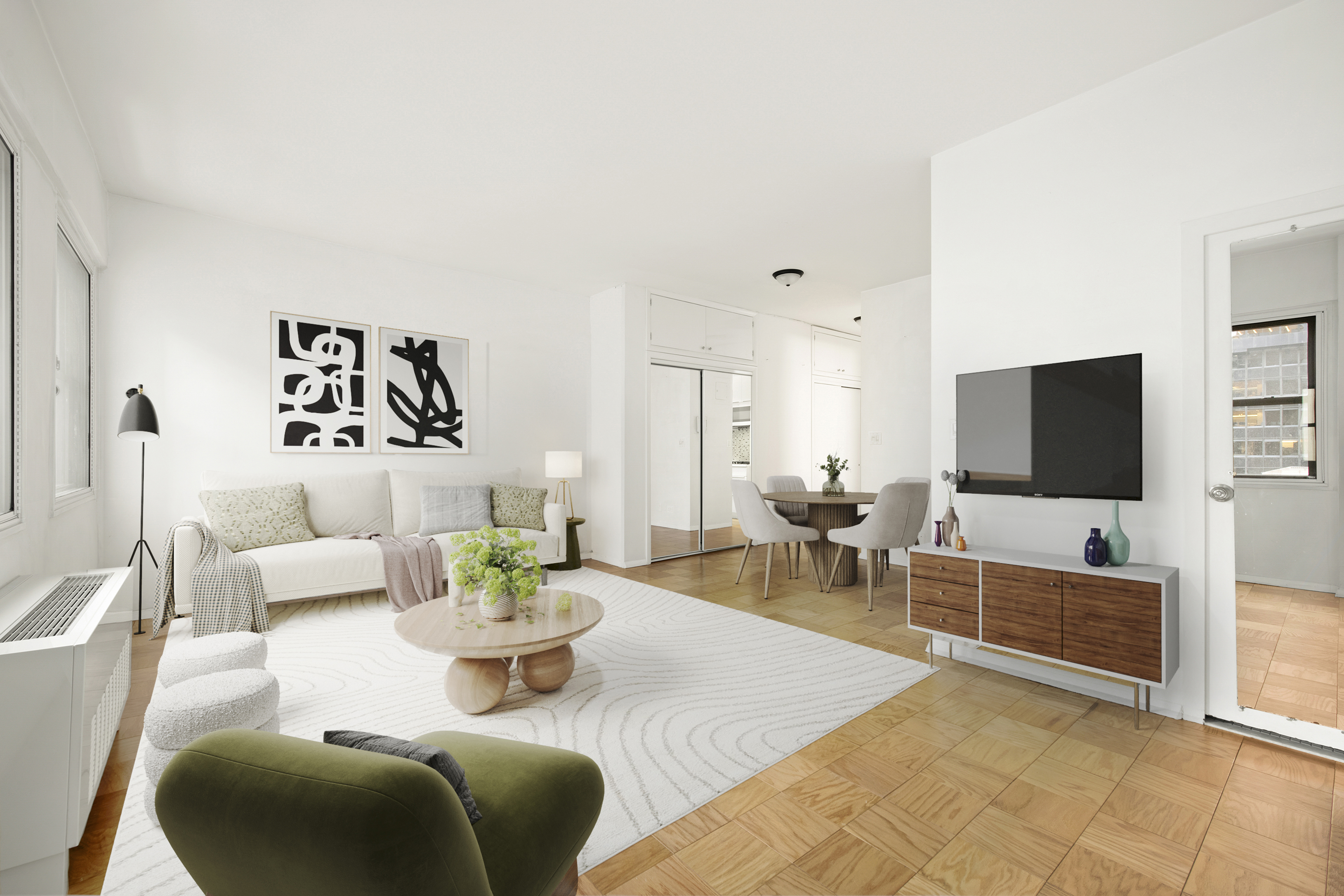 58 West 58th Street, Unit 10D Manhattan, NY 10019 - Photo 4 of 10 a living room with furniture and a flat screen tv