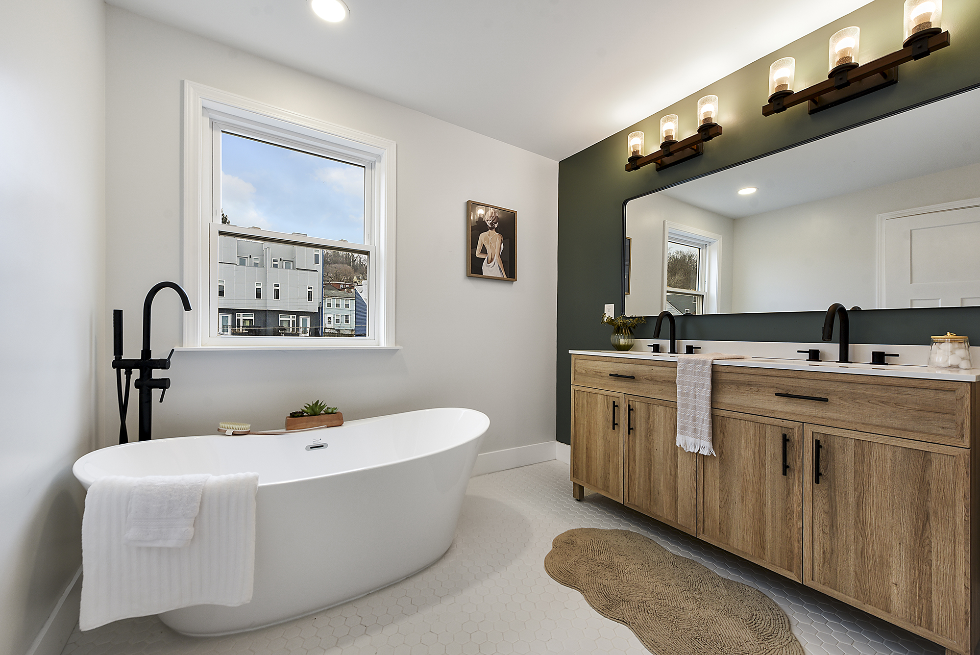 5412 Carnegie Street Pittsburgh, PA 15201 - Photo 2 of 55 a spacious bathroom with a double vanity sink a mirror and a bathtub