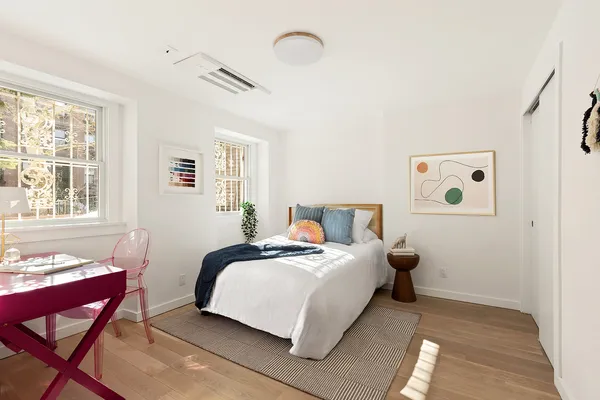 a bedroom with bed and a window