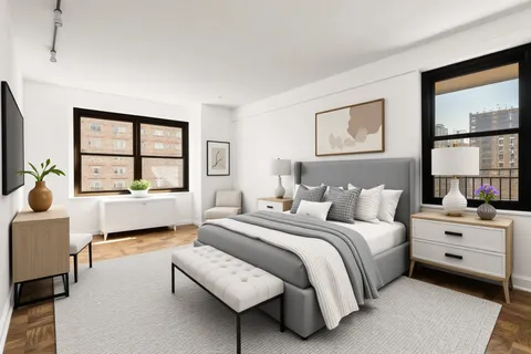 a bedroom with a bed and a large window