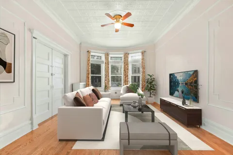 a view of a bedroom with a window and a ceiling fan