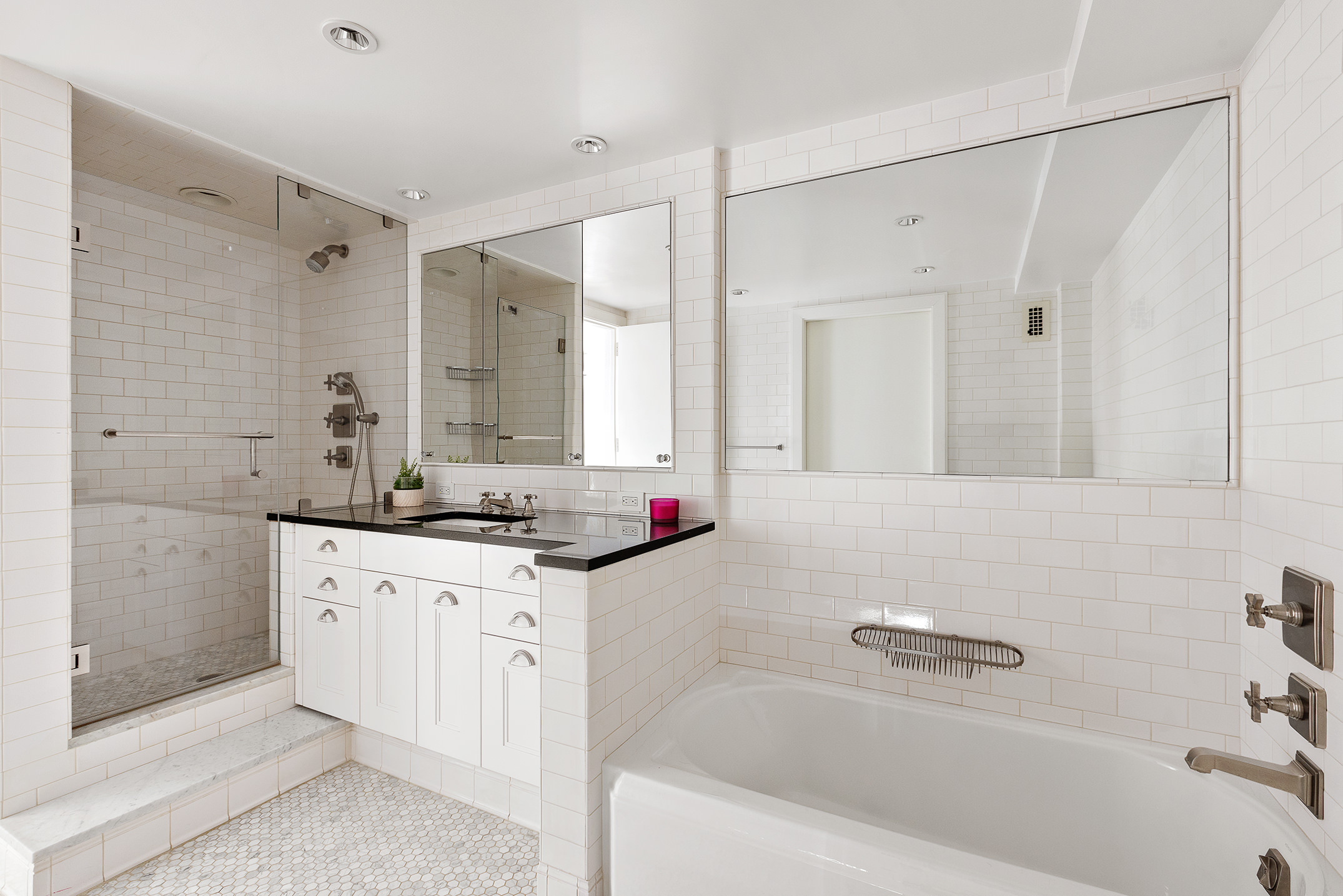 70 East 10th Street, Unit 14P Manhattan, NY 10003 - Photo 6 of 8 a bathroom with a granite countertop sink mirror and a bathtub
