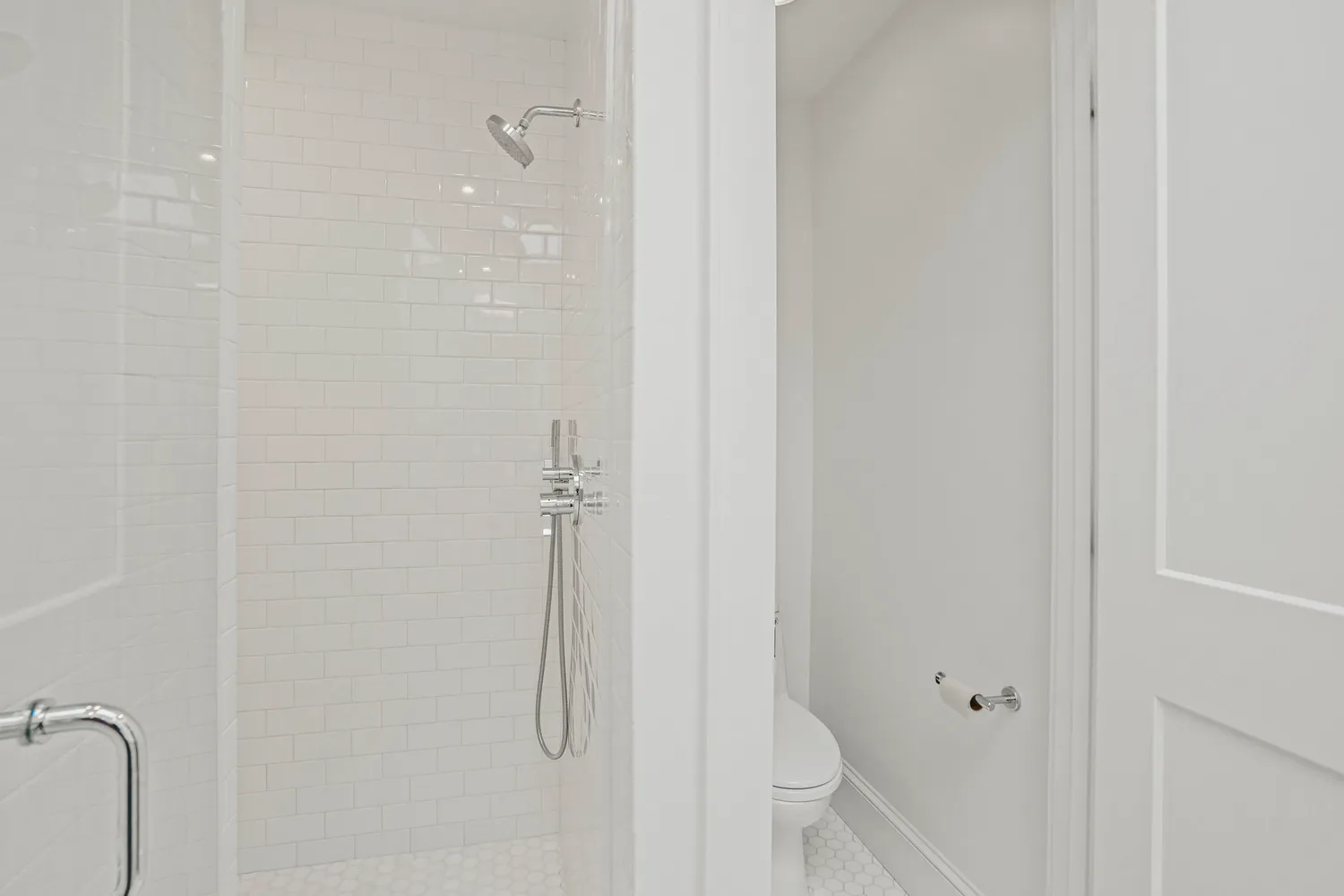 a bathroom with a glass shower door