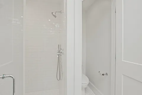 a bathroom with a glass shower door