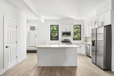 a kitchen with stainless steel appliances a sink stove and refrigerator