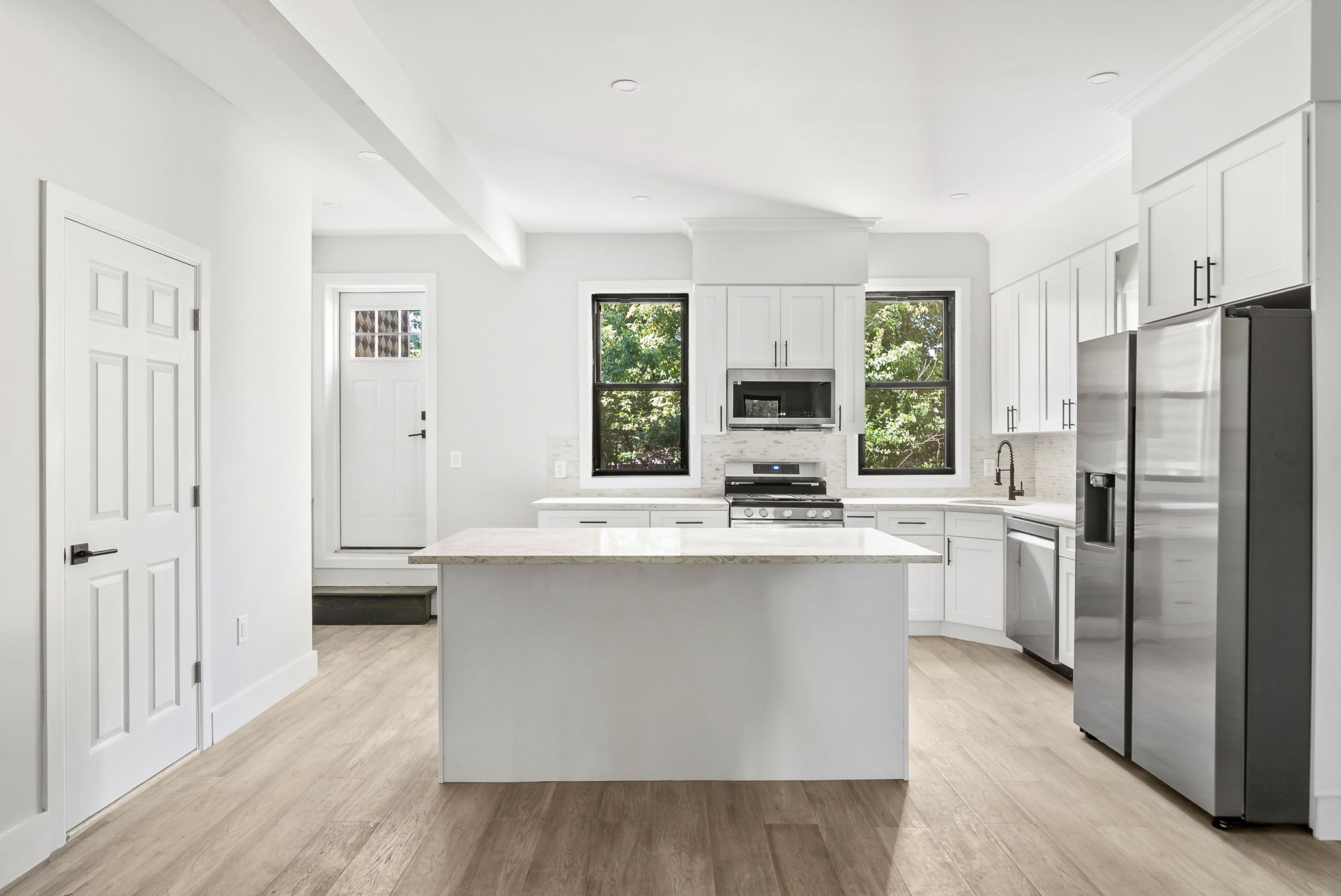 1414 30th Road Queens, NY 11102 - Photo 2 of 16 a kitchen with stainless steel appliances a sink stove and refrigerator
