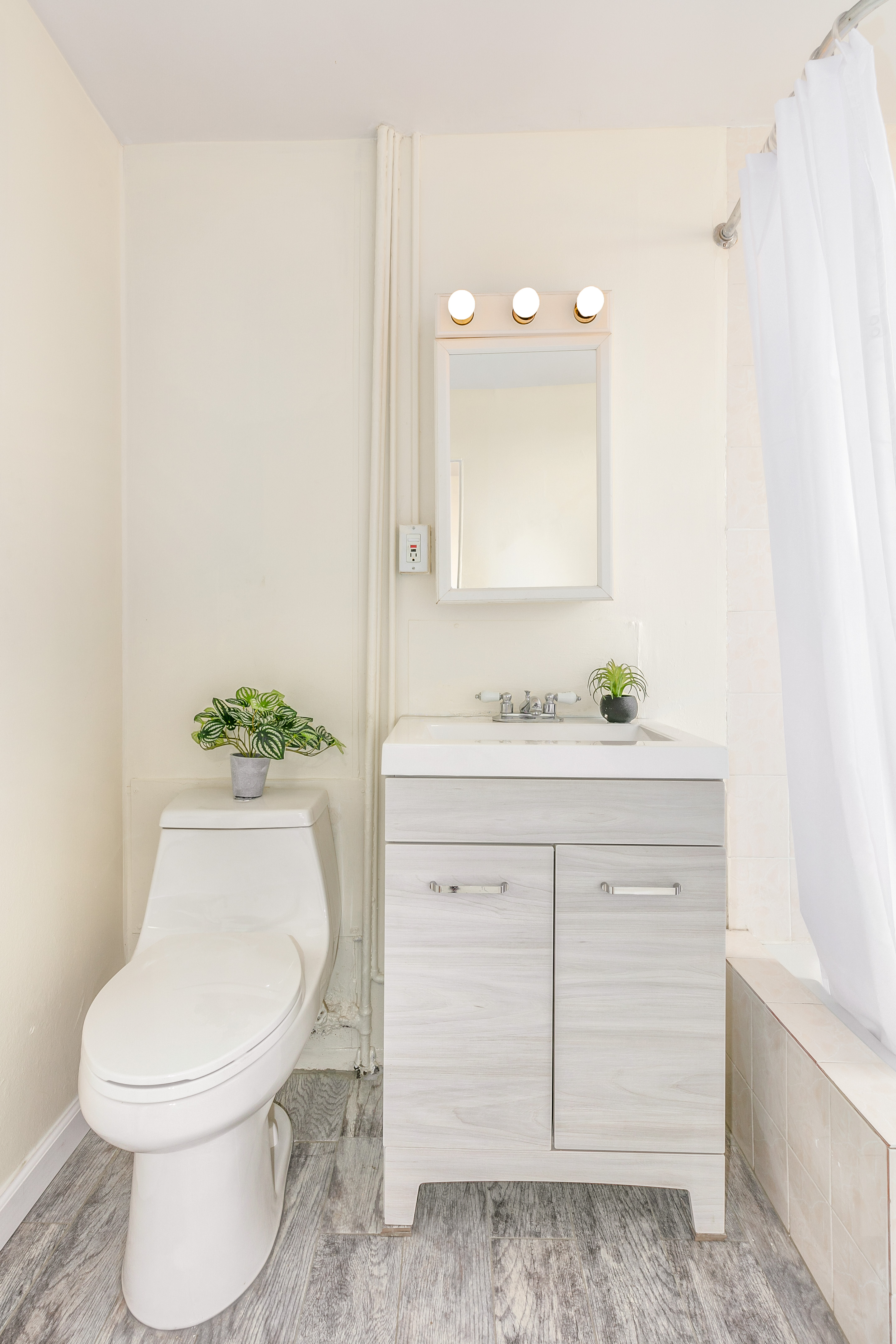 148 29th Street Brooklyn, NY 11232 - Photo 16 of 31 a bathroom with a sink a toilet and mirror