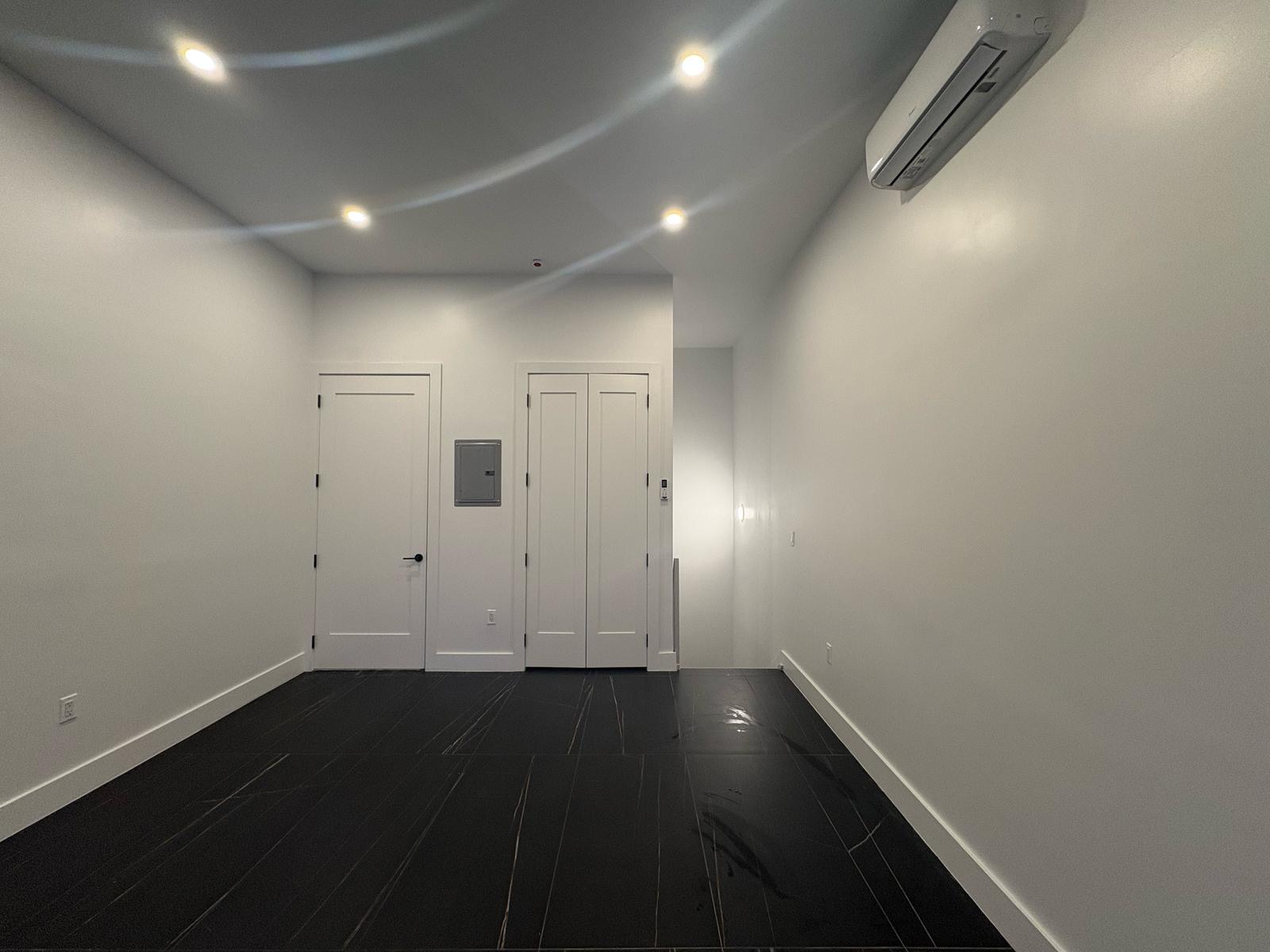 97 Seigel Street, Unit COMM Brooklyn, NY 11206 - Photo 6 of 7 a view of wooden floor in an empty room