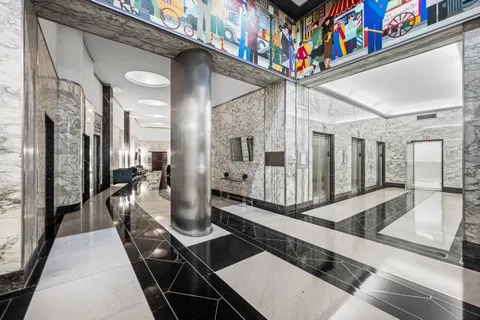 a very nice looking room with a large window and potted plants