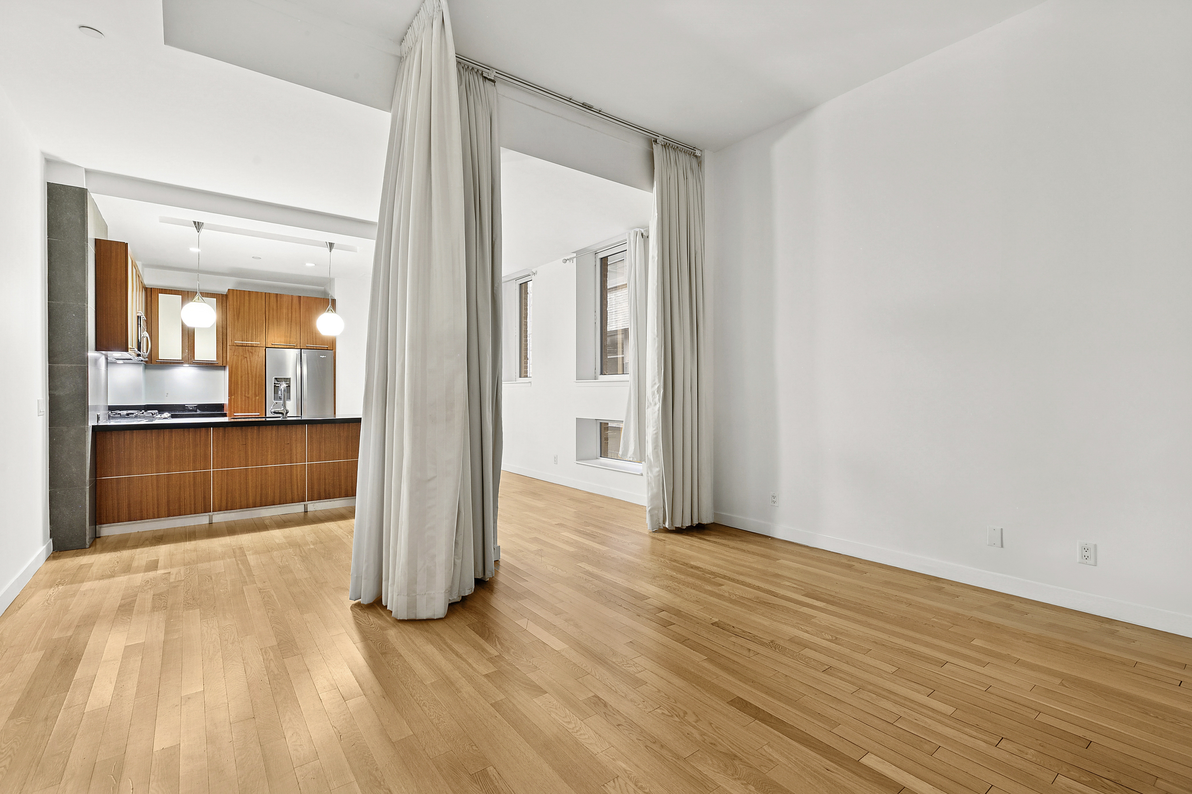 59 John Street, Unit 4H Manhattan, NY 10038 - Photo 2 of 19 a view of a room with wooden floor and a kitchen