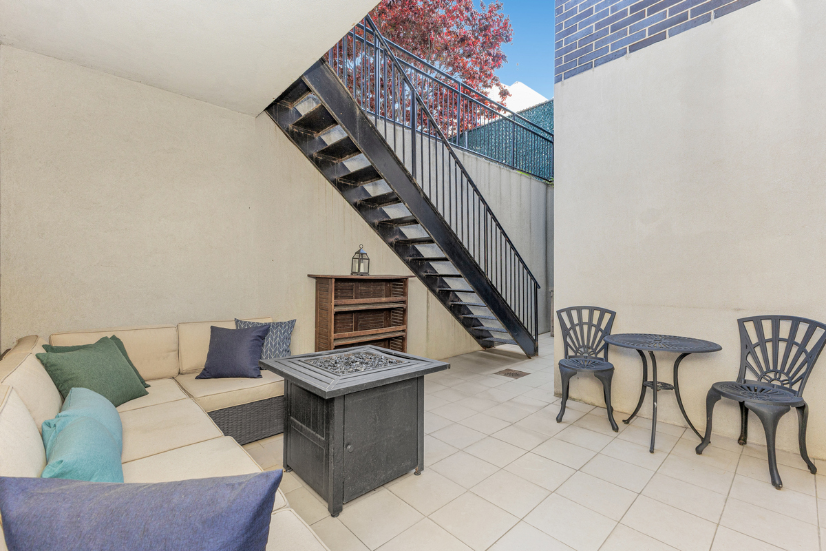 319 Humboldt Street, Unit 1B Brooklyn, NY 11211 - Photo 16 of 17 a living room with furniture and stairs
