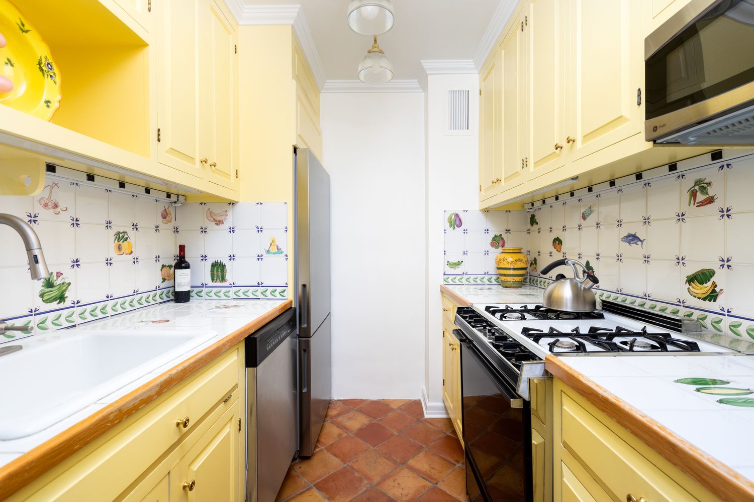 a kitchen with stainless steel appliances granite countertop a sink and a stove