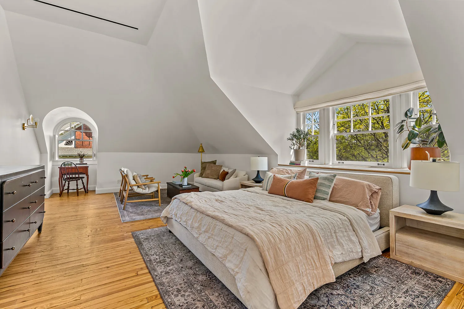 a bedroom with a bed and a large window