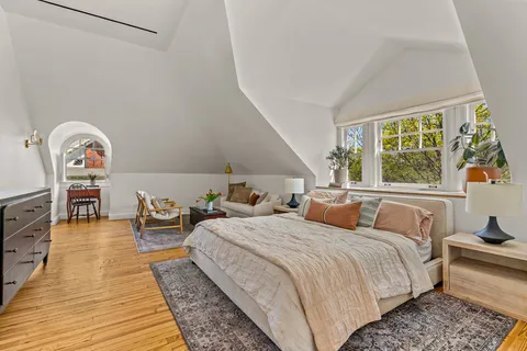 a bedroom with a bed and a large window