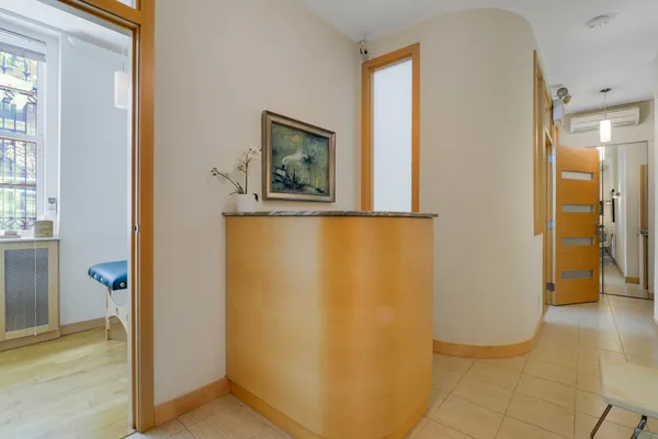 a view of a hallway with paintings on the wall