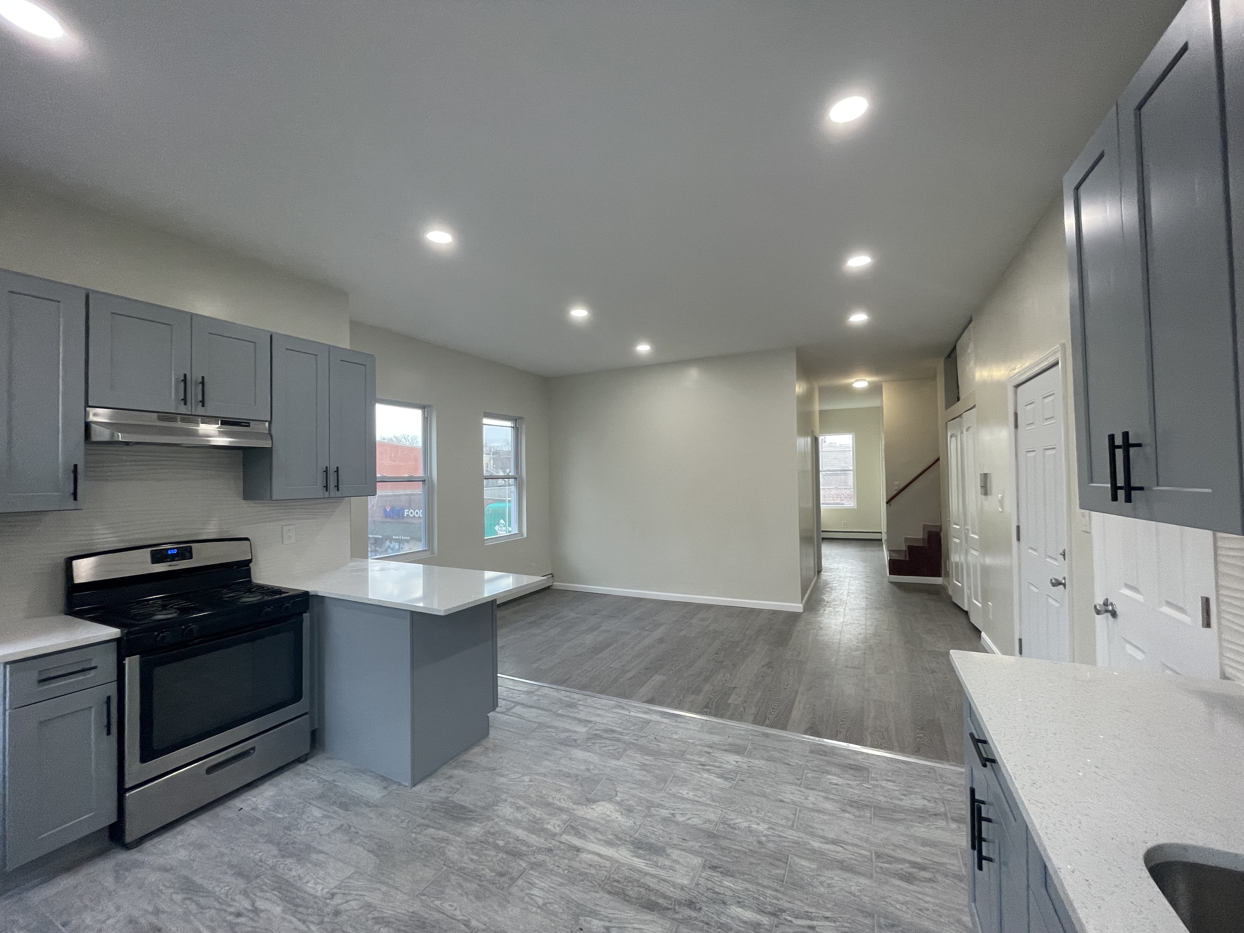 142 Driggs Avenue, Unit 3 Brooklyn, NY 11222 - Photo 1 of 8 a kitchen with stainless steel appliances granite countertop a sink stove and refrigerator