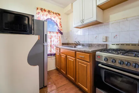 a kitchen with stainless steel appliances granite countertop a stove and a microwave