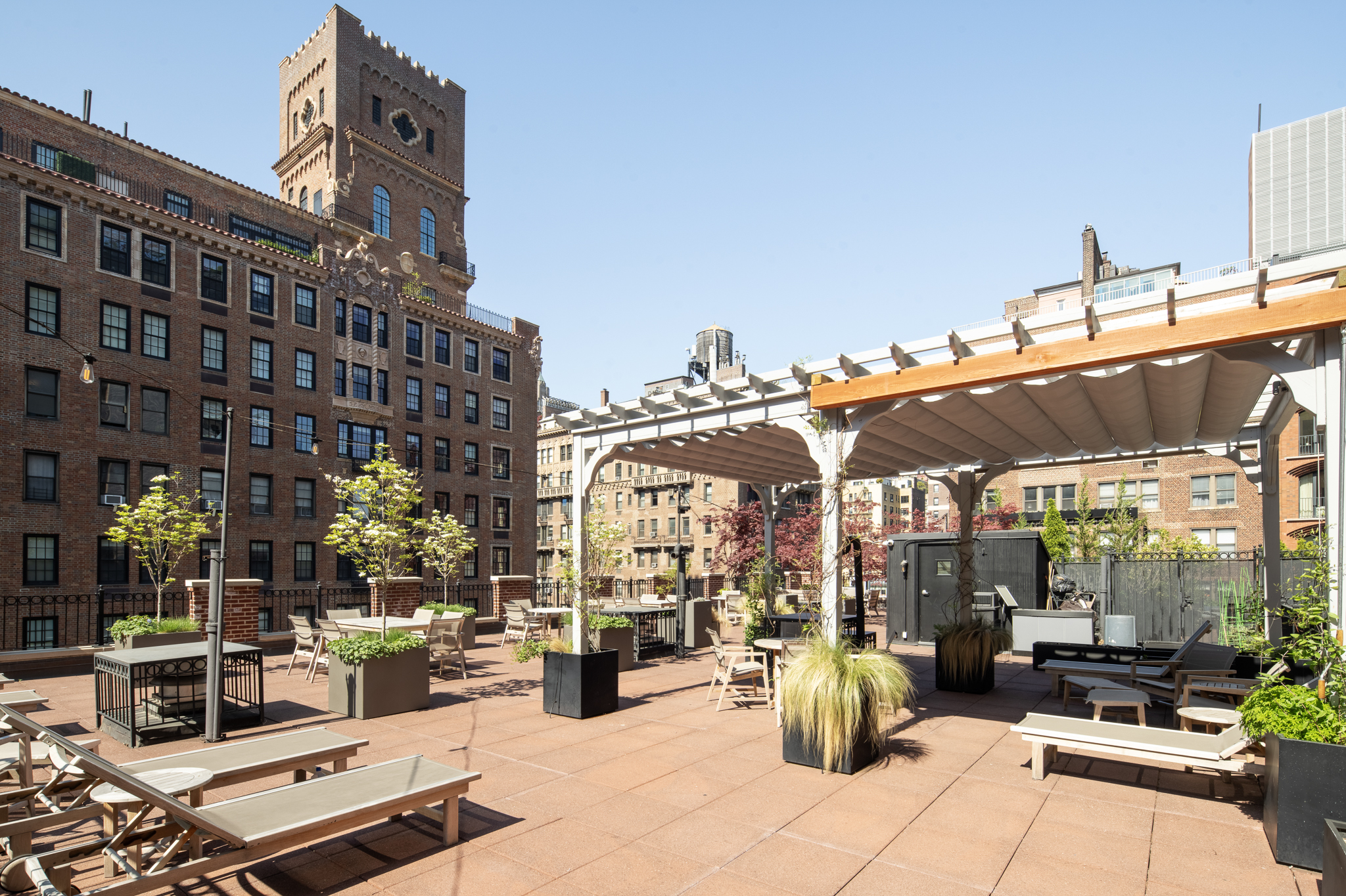 23 East 10th Street, Unit 508 Manhattan, NY 10003 - Photo 17 of 21 a view of the patio with dining table and chairs under an umbrella