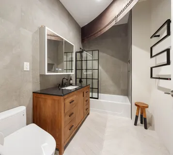 a bathroom with a sink a toilet and shower