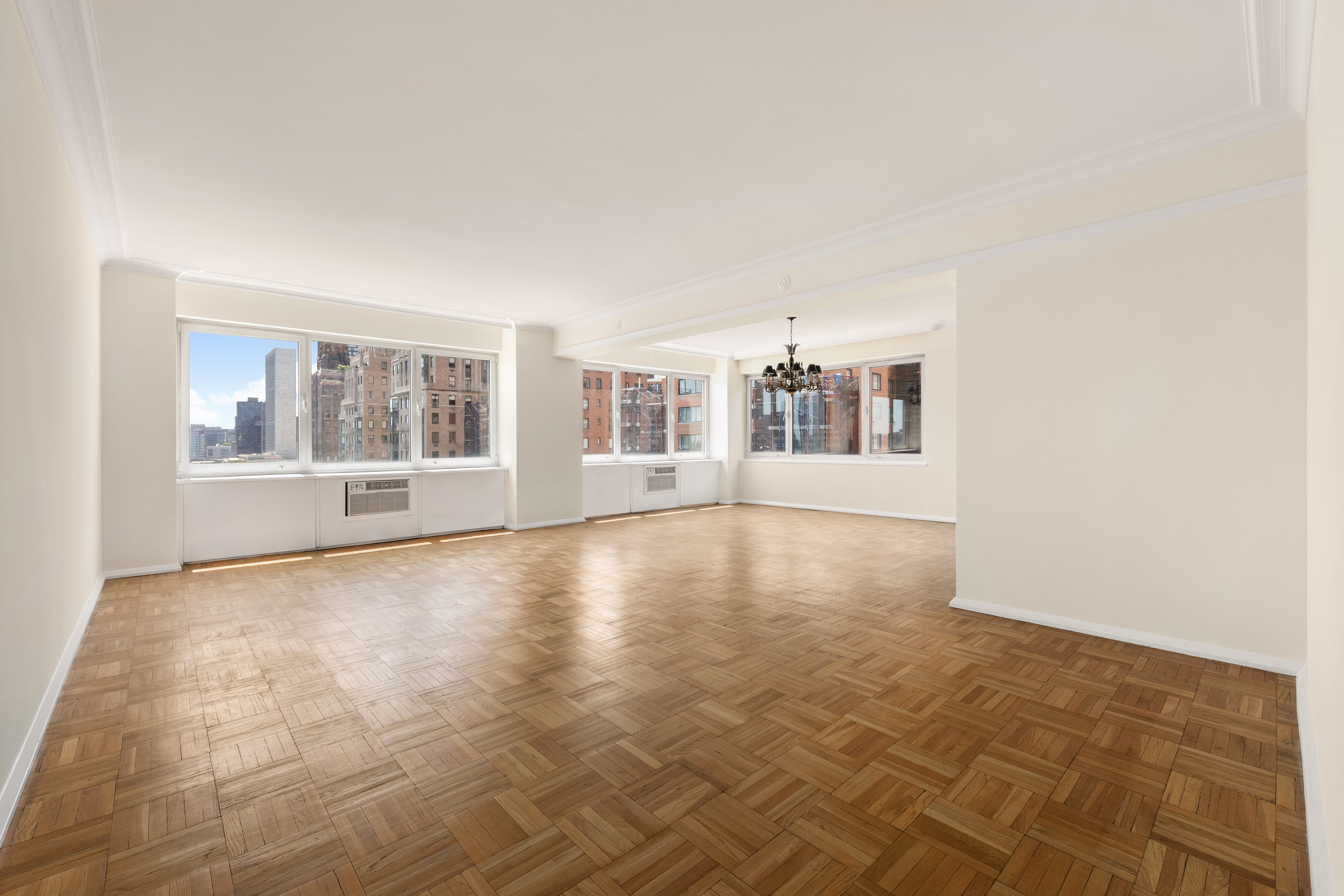 45 Sutton Place South, Unit 14N Manhattan, NY 10022 - Photo 5 of 19 an empty room with windows