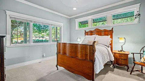 a bed sitting in a bedroom next to a window
