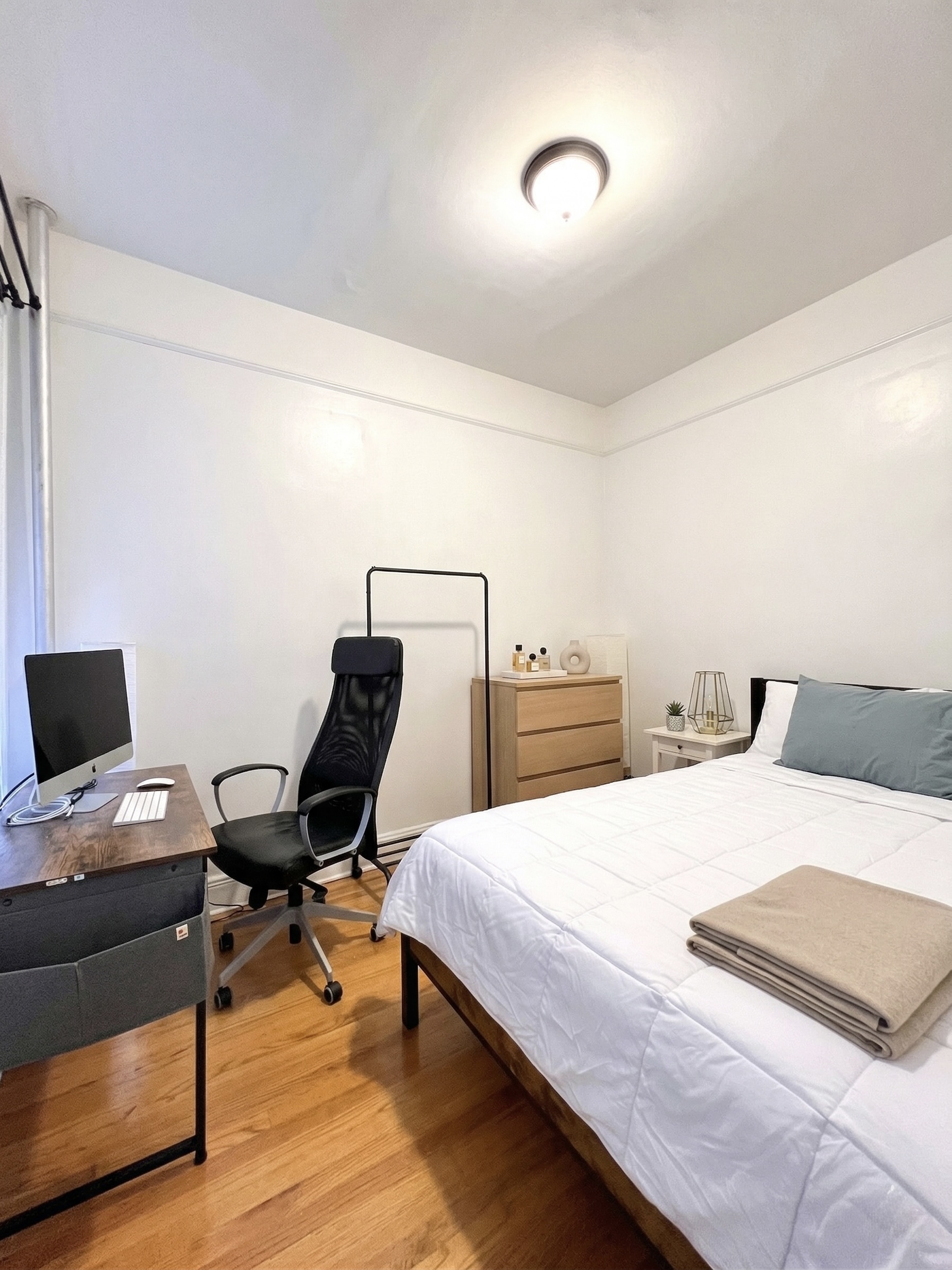 90 Thompson Street, Unit A2 Manhattan, NY 10012 - Photo 4 of 6 a bedroom with a bed and a computer on a desk