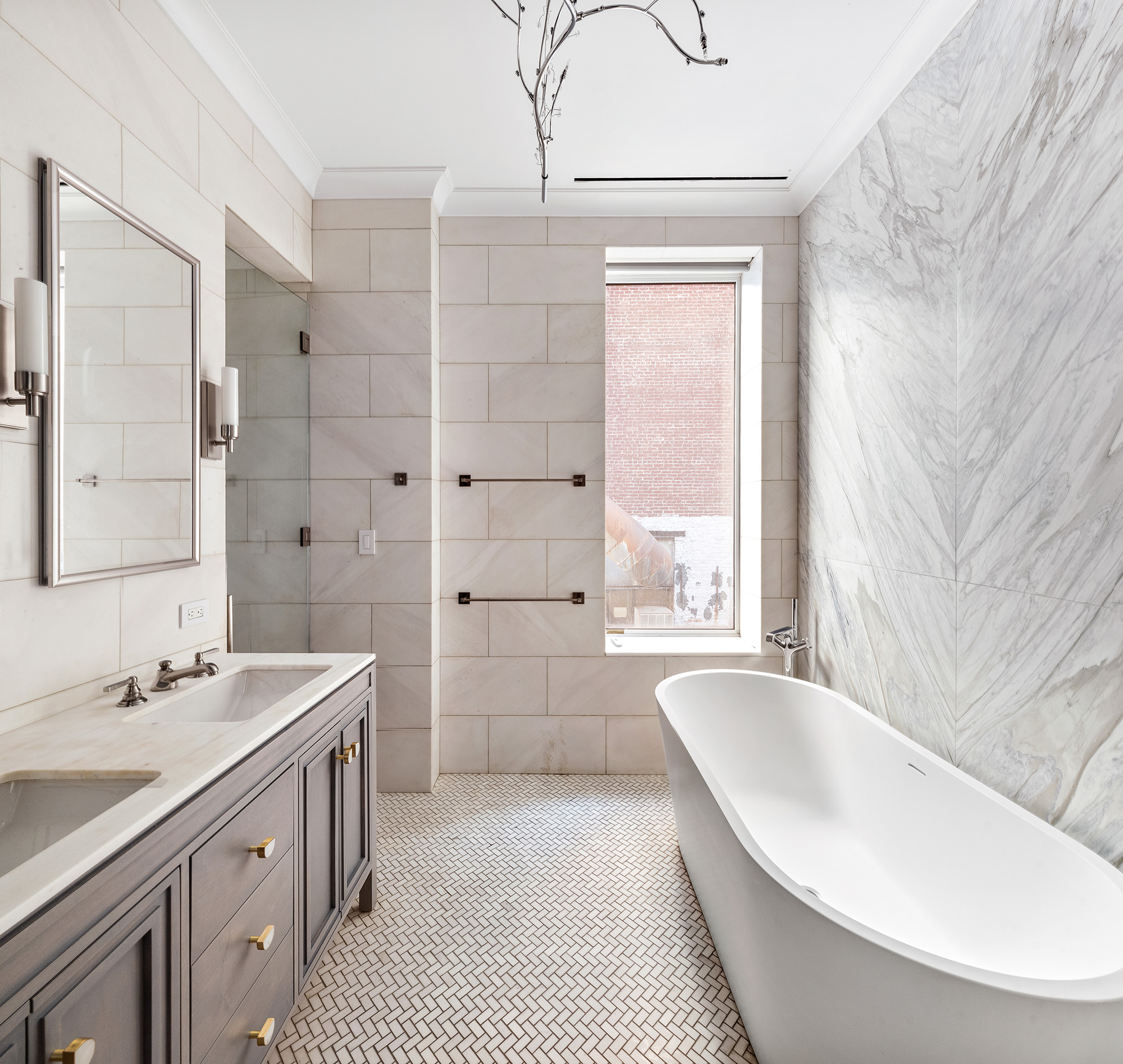 26 West 20th Street, Unit 3 Manhattan, NY 10011 - Photo 13 of 19 a spacious bathroom with a tub sink and mirror