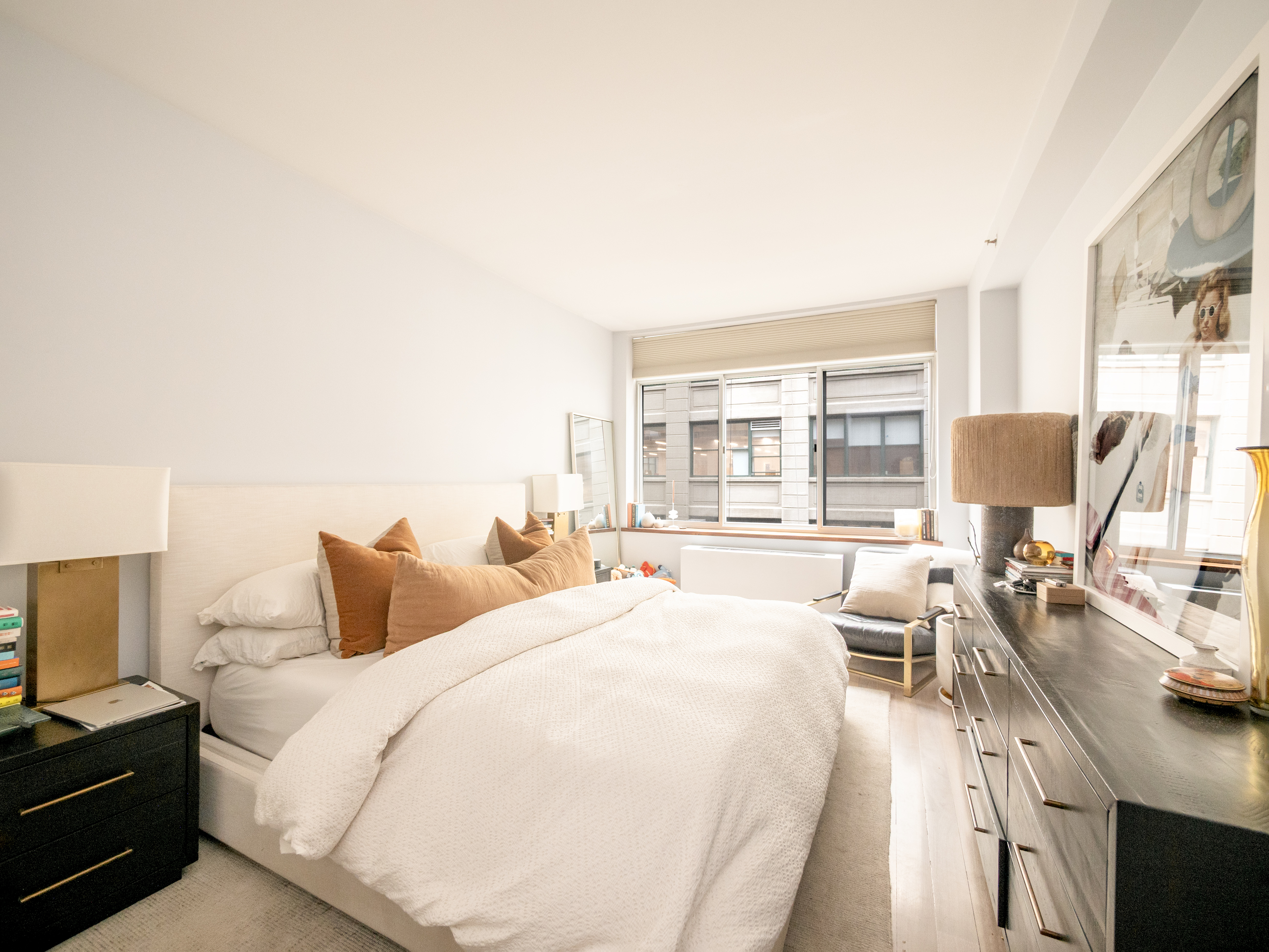 84 Front Street, Unit 5E Brooklyn, NY 11201 - Photo 7 of 11 a bedroom with a bed a large window and a flat screen tv