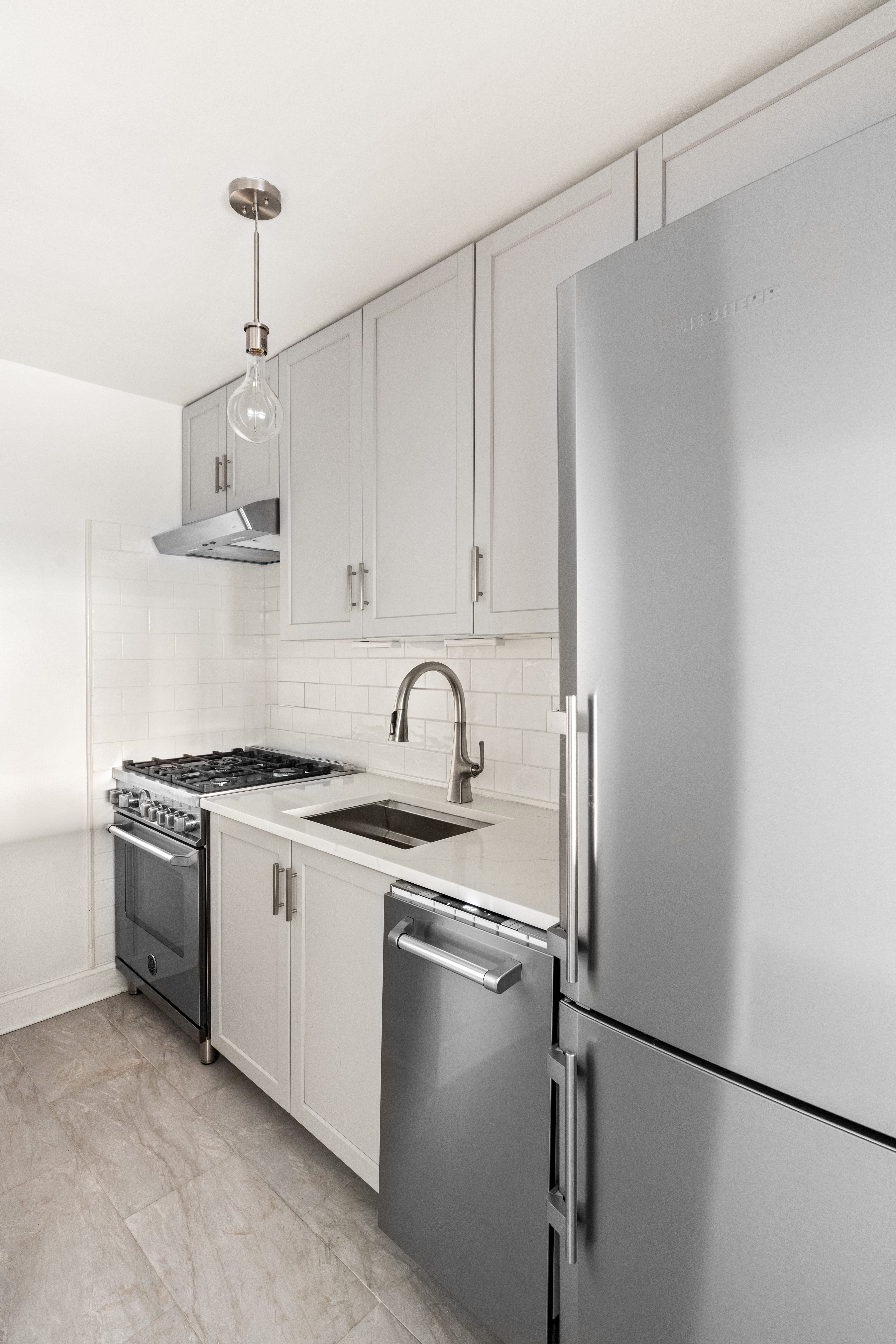 32 Gramercy Park South, Unit 6F Manhattan, NY 10003 - Photo 2 of 11 a kitchen with stainless steel appliances granite countertop a sink stove and refrigerator