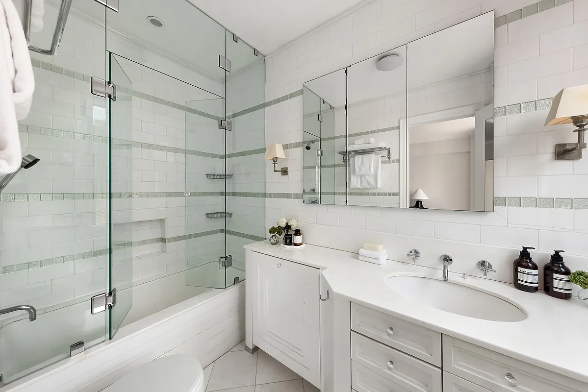 180 East 79th Street, Unit 14B Manhattan, NY 10075 - Photo 15 of 18 a bathroom with a sink and a shower