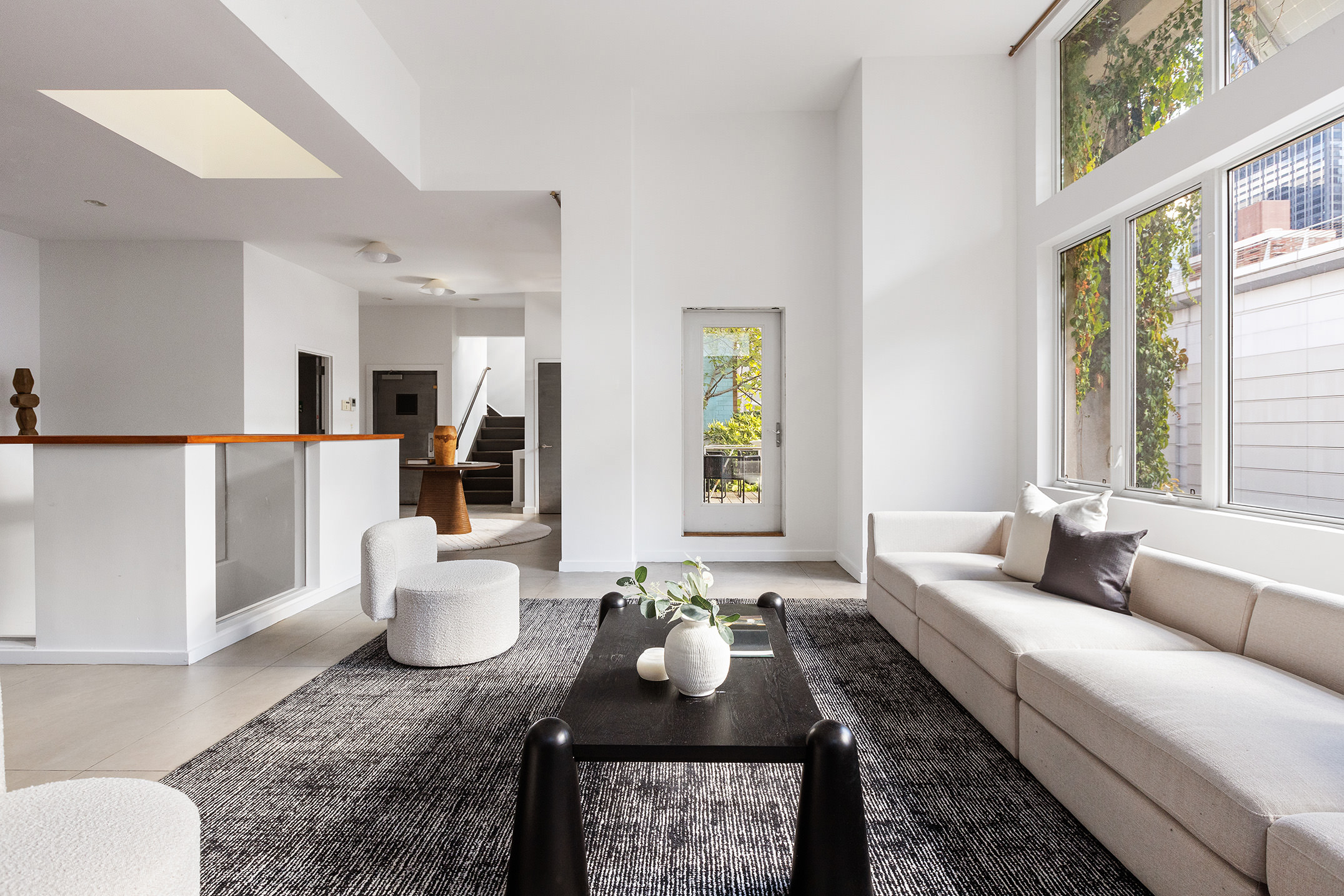 345 West 54th Street Manhattan, NY 10019 - Photo 6 of 22 a living room with furniture and a large window