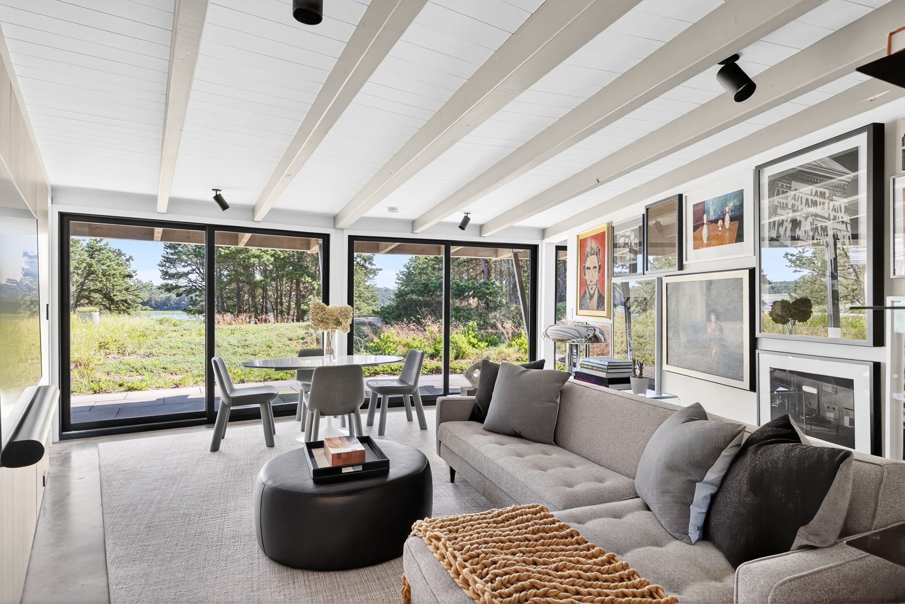 375 King Phillip Road Wellfleet, MA 02667 - Photo 13 of 27 a living room with furniture and a floor to ceiling window