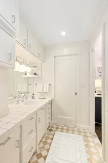 a bathroom with a sink shower and a mirror