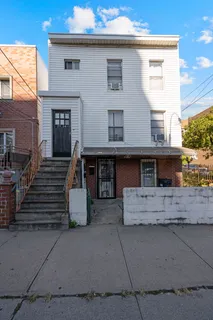 a view of a house with a stairs and a yard